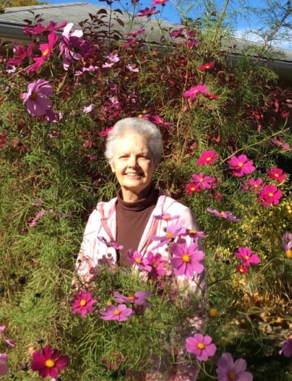 Author Joanne Gucwa among Cosmos Flowers